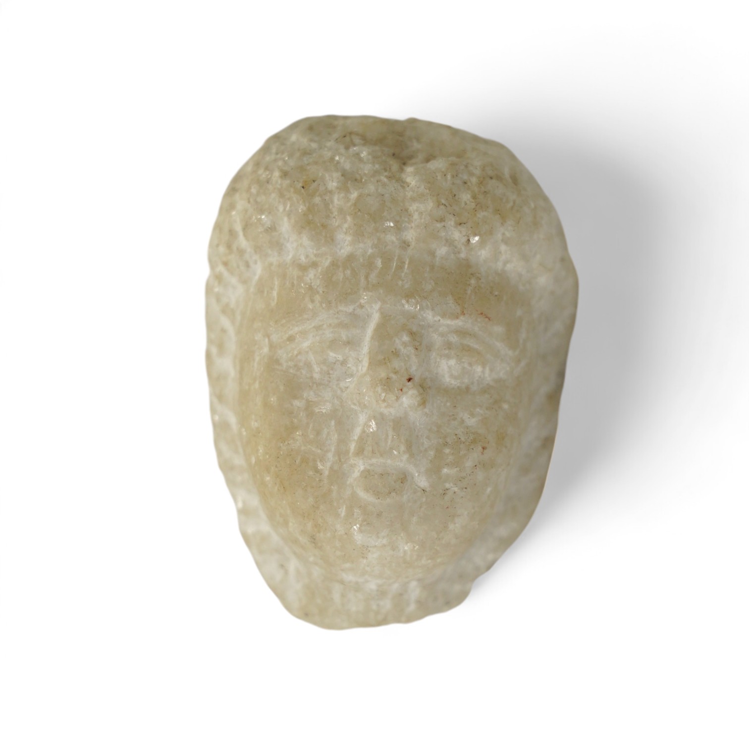 A carved marble double sided head of Eros?, possibly 2nd century BC, 8cm. Condition - commensurate with age